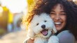 © Radomir Jovanovic - A joyful woman embraces her fluffy dog during a sunny evening walk in the park, sharing a moment of happiness and companionship