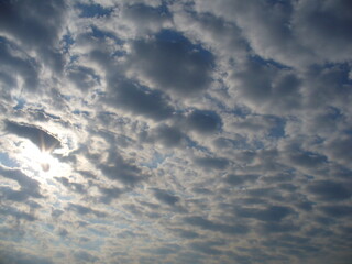 Poster - Sunny blue sky with sunlight and Stratocumulus clouds - natural background. Topics: pattern, texture, weather, meteorology, sun energy, season, beauty of nature, air space