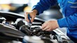 © Sampao - Hands of a mechanic working on a car engine, using a screwdriver to repair and maintain automotive parts in a workshop for vehicle servicing and diagnostics.