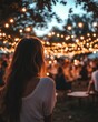 © peppastocker - An outdoor event with a woman at the rear, surrounded by twinkling lights.
