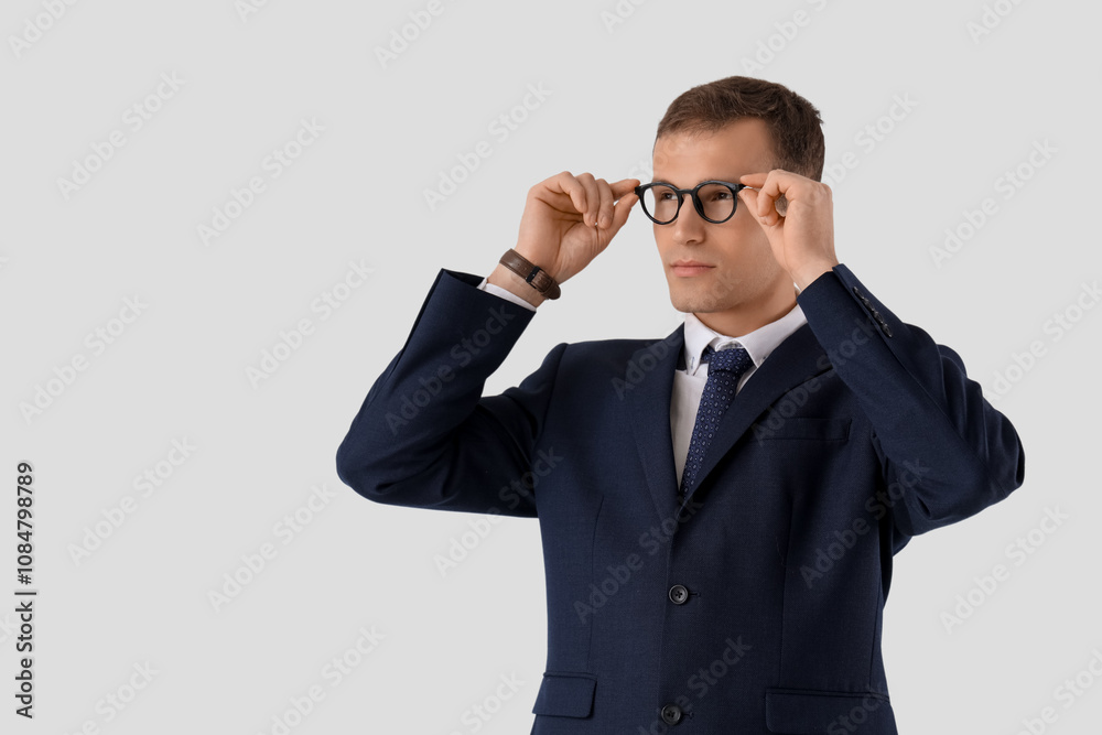 Handsome businessman in suit with eyeglasses on white background