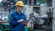 © MC Portfolio - Engineer inspecting machinery with a tablet. Industrial safety photography in a labor union heavy machinery warehouse setting.