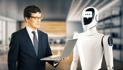 Poster - Businessman interacting with AI robot in office setting, holding laptop, futuristic concept of collaboration between humans and AI.