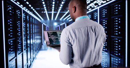 Wall Mural - Happy Engineer In Data Center Server Room Configuring AI