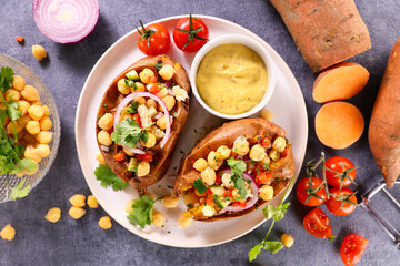 Wall Mural - baked sweet potato stuffed with vegetables and sauce