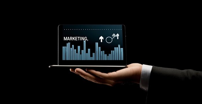 Businessman's hand holding a tablet with a digital marketing icon, the text 