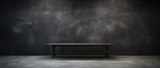 Aufkleber - A dark background wall with an empty table in front, creating a minimalist and contemplative atmosphere in the space.

