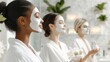 © mashimara - A group of three women with face masks and towels smiling confidently, each wearing white robes, in a calming mint background, promoting skincare.