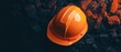© NEW KUNG - Orange Hard Hat on Dark Rocks  Construction Safety