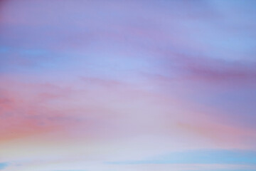 Wall Mural - Sky with soft and fluffy pastel orange pink and blue colored clouds. Sunset background. Nature. sunrise.