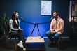 © Serhii - Show host interviewing woman during live stream, talking about fashion and style trends, disagreeing with her opinions. Man arguing with social media celebrity, recording podcast