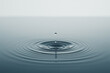 © Vasili - A single water droplet creates ripples on a calm surface of a blue lake, symbolizing peace and tranquility in a minimalist composition.