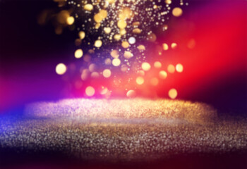 Aufkleber - Gold glitter and bokeh lights against a black background.