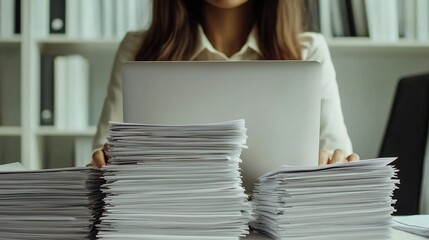 Poster - Professional Woman Working on Laptop Surrounded by Stacks of Documents in Modern Office Environment, Displaying Focus and Productivity Models of Business Culture