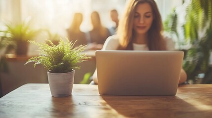 Modern home office scene featuring a focused individual in a comfortable chair,utilizing laptop an web camera for remote hiring success,accompanied by natural lighting ,potted plant decor,and spacious