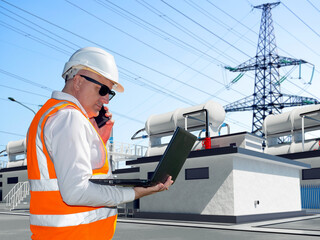 Poster - man power plant employee. guy is energy company employee. man power plant engineer speaks on phone. 