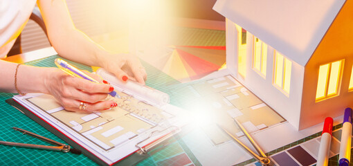 Poster - Architect hands at desk. Designer draws architectural plan for room. Compasses and markers near house model. Cropped architect at work. Residential real estate design. Architectural bureau services