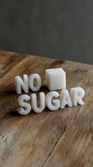 Poster - Sugar cubes forming the words no sugar with a sugar cube placed between no and sugar on a wooden table represent the concept of sugar reduction and sugar free lifestyle