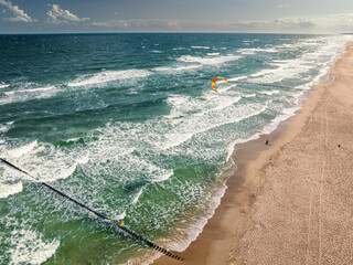 Wall Mural - Kitesurfer riding on waves at storm, Baltic Sea