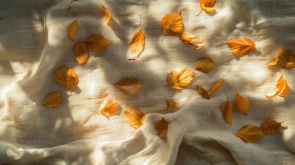 Wall Mural - Autumn Leaves Gently Scattered on Textured Fabric Showcasing the Warm Colors of Fall with Soft Natural Light Enhancing the Scene's Beauty and Tranquility