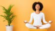 © EvgeniiasArt - Tranquil meditation: woman practicing yoga with tea against a vibrant yellow background