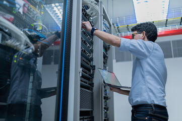 computer engineer is setting up network in server room,systems maintenance technician,male engineer 