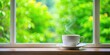 © Sayfar - Coffee cup on window sill with blurred green window background