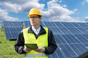 Poster - Engineer with digital tablet on a backround of solar panels