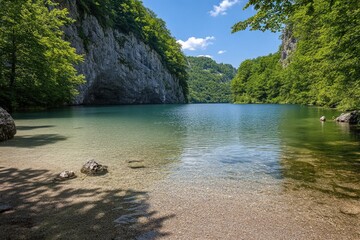 Wall Mural - A serene lake surrounded by trees and rocks, perfect for nature photography or as a background for outdoor-themed designs