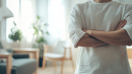 Poster - Man is standing with his arms crossed in a modern, minimalist living room, conveying a sense of confidence and ownership