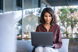 © Stock 4 You - Beautiful middle eastern indian female freelancer working remotely on business project. Young latin, arabian freelance woman student worker using laptop for study sitting outdoors at cafe. Copy space
