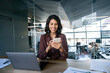 © Stock 4 You - Young Indian business woman manager ceo using cell phone mobile app laptop. Smiling Latin Hispanic mature female businesswoman holding smartphone in office trading, reading, working online. Copy space