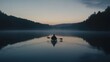 © musa - A lone kayaker paddles through a misty lake at dawn, with the silhouette of trees and hills in the background.