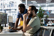 © DC Studio - Developer requesting help from colleague while working with machine learning tech advancing AI critical to autonomous systems. IT expert and helpful coworker transforming data into predictive models