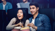 © Prostock-studio - Happy young couple with popcorn watching movie in cinema