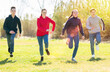 © JackF - Group of joyful teenagers running down in the spring park