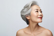 © Ron Dale - Chinese woman face with smooth healthy neckline skin. Korean, Chinese or Japanese Beautiful aging 50-60 years old young looking woman happy smiling, beauty health skincare and cosmetics ad concept