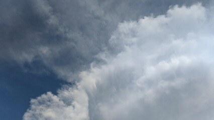 a towering cumulus cloud dominates the sky, its fluffy, white form contrasting against the deep blue