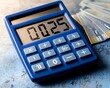© juni studio - Metallic blue calculator with 2025 displayed and euros fanned out on a cool metallic background ,