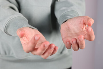 Wall Mural - man holding something on light background, closeup