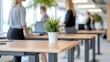 © Preecha - Close-up of a group of employees using standing desks in a corporate office, wellness theme, professional setting with copy space for text, deep depth of field