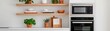 © lnwAI - A modern kitchen featuring stylish shelves, greenery, and sleek appliances, creating a cozy yet contemporary atmosphere for culinary activities.
