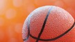 © gacor - Close-up of a basketball with an orange blurred background.