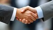 © MINHOO - Two hands engaged in a handshake, symbolizing agreement or partnership.