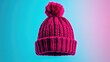 © ArtificialHorizons - Vibrant magenta knitted cap featuring a fluffy bobble, showcased against a gradient blue to purple background, highlighting its texture and color.