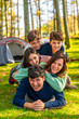 © unai - Cheerful family laughing while lying down together at forest