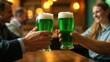 © Helga P-A. - Two people clink glasses of green beer in a celebratory toast at a pub. Concept of St. Patrick's Day festivities and friendship.