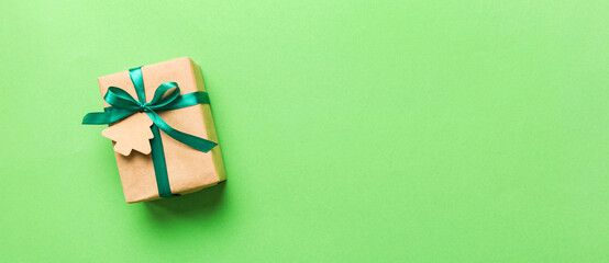 Wall Mural - wrapped christmas or other holiday handmade present in paper with colored ribbon. Present box, decoration of gift on colourfull table, top view with copy space