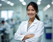 © Premium Stock - inside a laboratory, a female doctor standing ,arms crossed, smiling