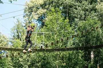 Wall Mural - experience an exhilarating high ropes course adventure nestled among vibrant and lush green trees al